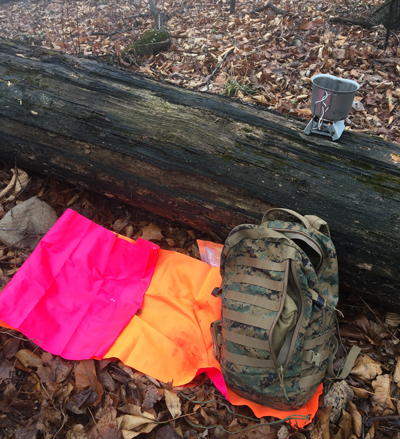 Carrying a military backpack and gear while camping in the forest