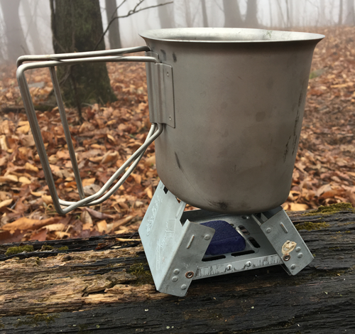 Portable small stove used for cooking small meals while forest camping
